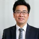 Photo of Hiroshi Tanaka, a man in a suit, possibly a hotel manager.