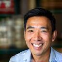 Photo of Li Wei, a man smiling in a market setting.