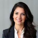 Photo of Maria Gonzales, a woman with a professional look wearing a business suit.